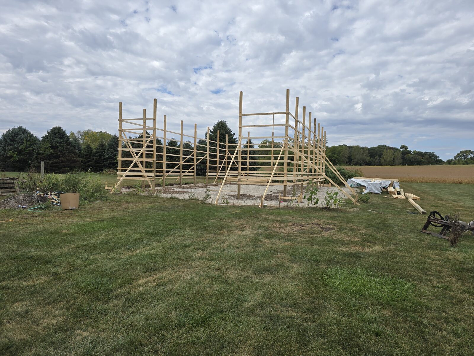 Post frame shop construction progress showing engineered truss framing in Millington Illinois