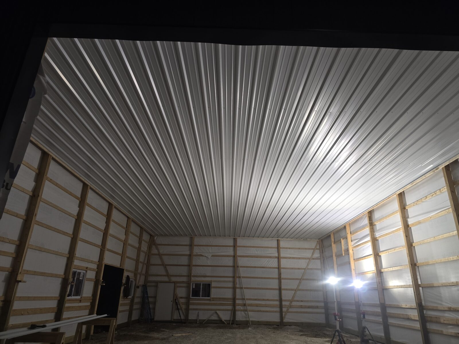 Finished ceiling and blown-in insulation inside 36x56x16 insulated post frame shop in Millington Illinois