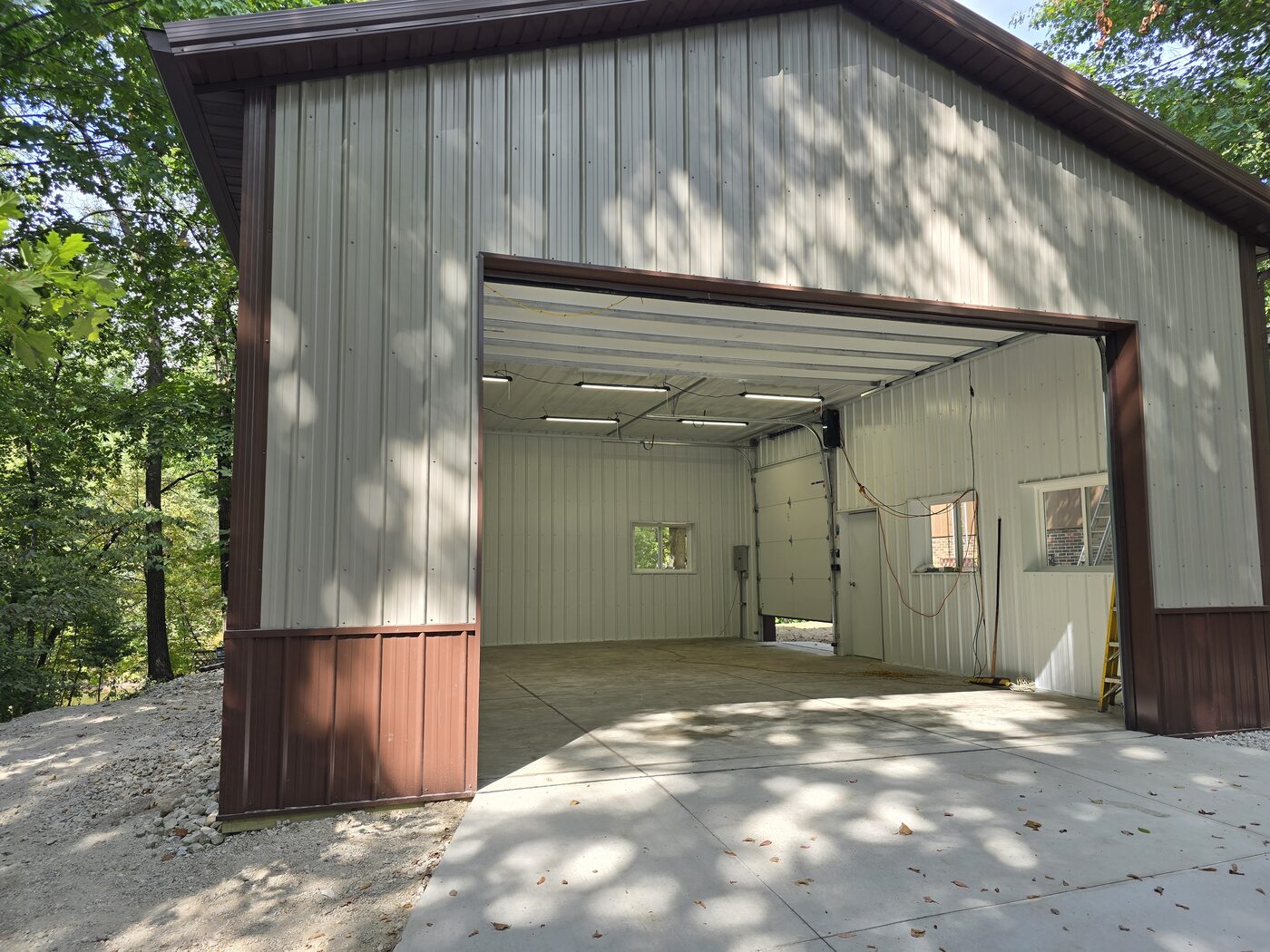 Finished interior of custom post frame garage with overhead door in Marseilles IL