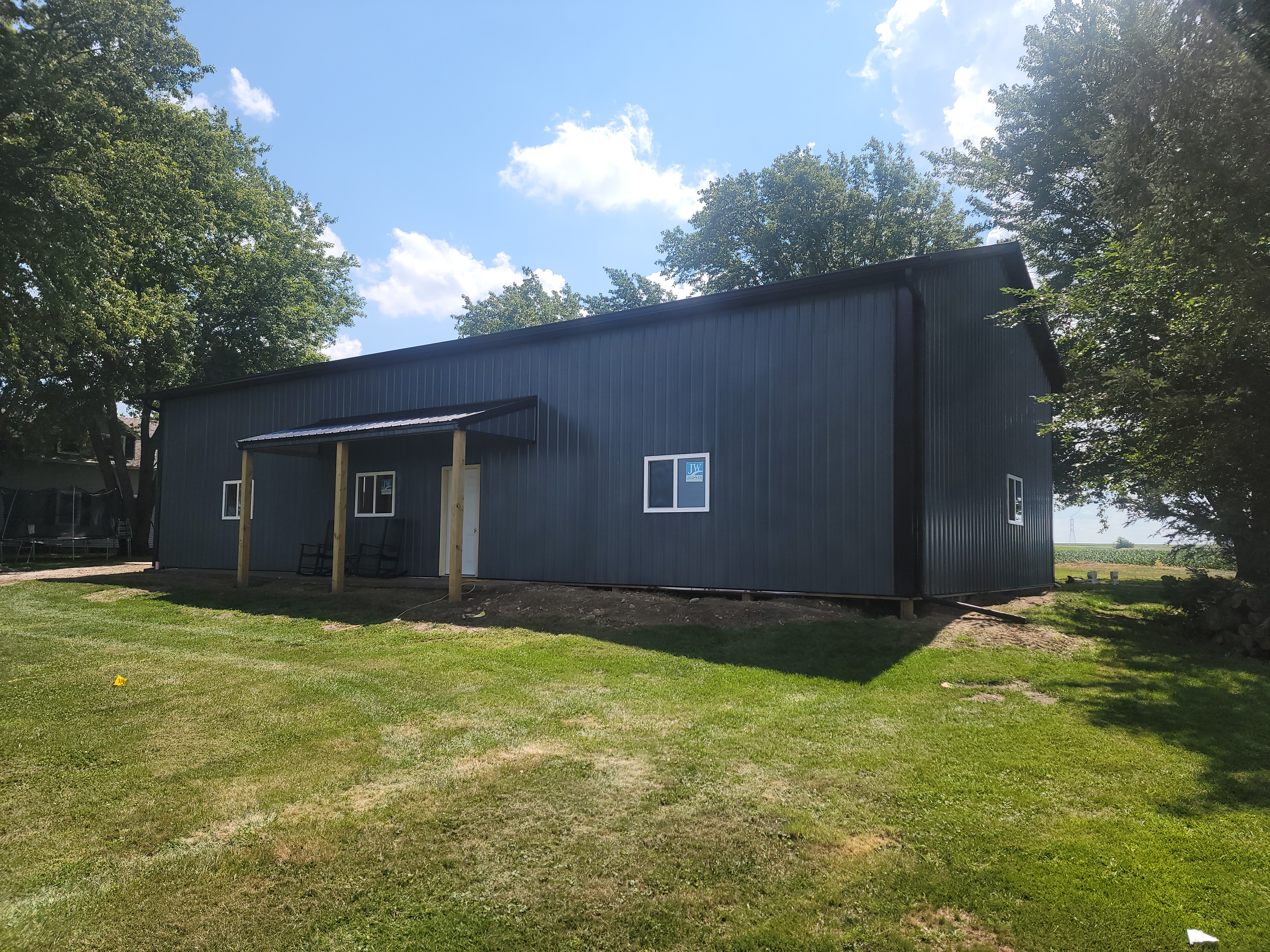Side exterior view of 36x64 post frame garage with covered porch in Ottawa Illinois